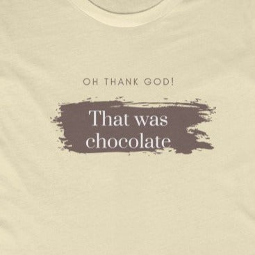 Natural color Tee Shirt with brown smudging and brown and white wording: Oh, thank god! That was just chocolate